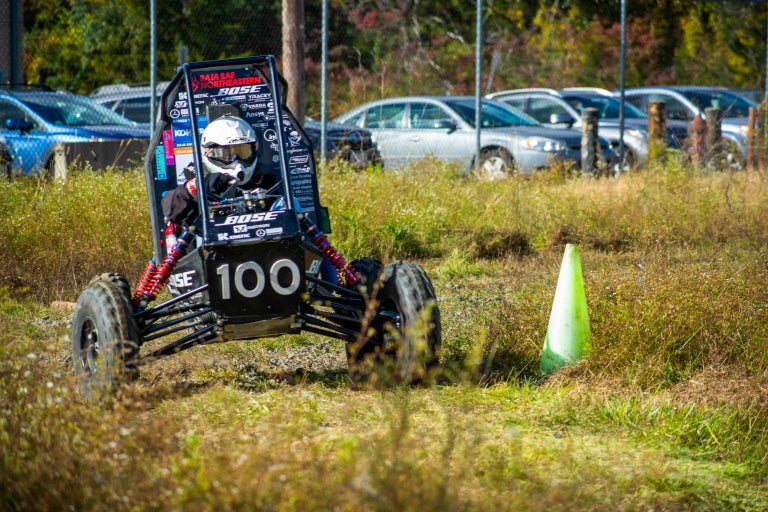 car going around a code on grass