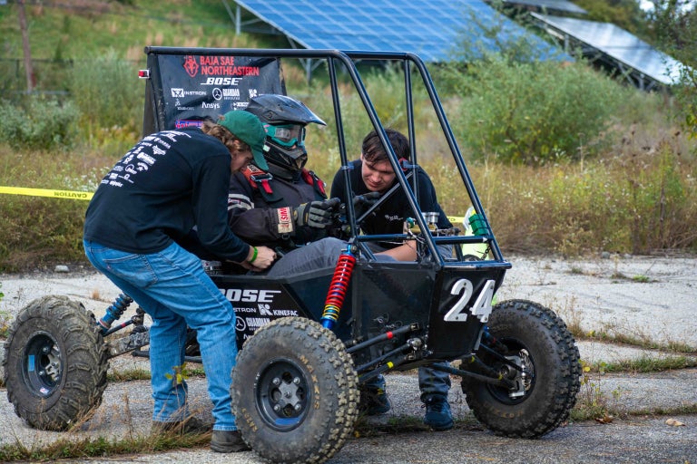 team members working on car